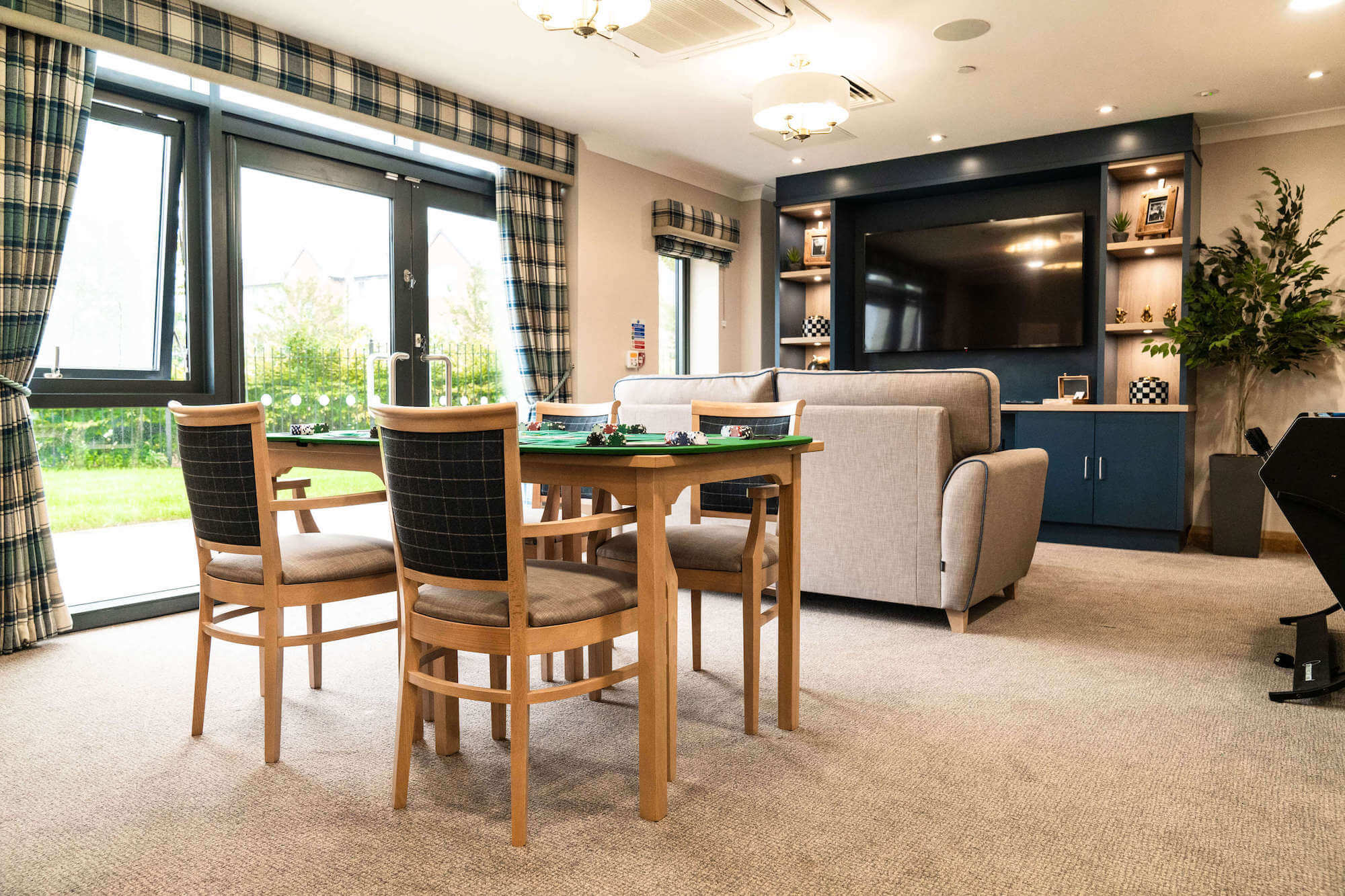 Chess table and comfortable sofa in the games room at Alexandra Mill Care Home.